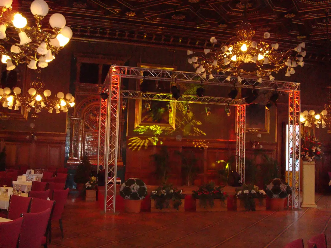Klassischer Festsaal mit Traversenaufbau und Blumendekor